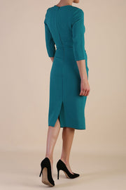 model wearing diva catwalk ubrique pencil dress with a keyhole detail and sleeves in parasailing green