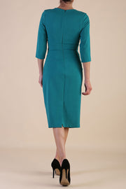 model wearing diva catwalk ubrique pencil dress with a keyhole detail and sleeves in parasailing green