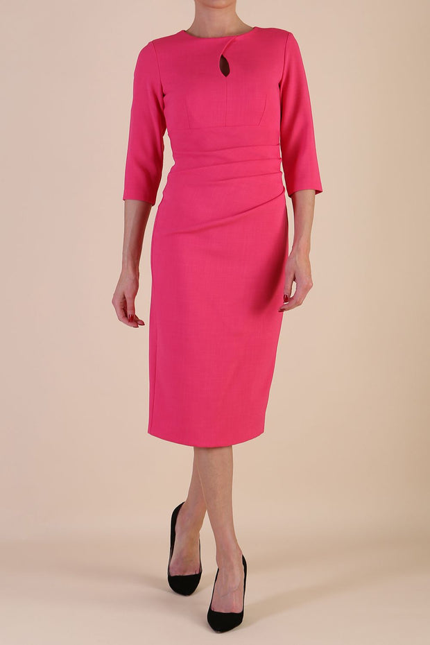 model wearing diva catwalk ubrique pencil dress with a keyhole detail and sleeves in fuchsia pink back