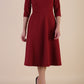 Brunette model is wearing diva catwalk casares swing dress with a keyhole neckline three quarter sleeve dress with pocket detail in wine front