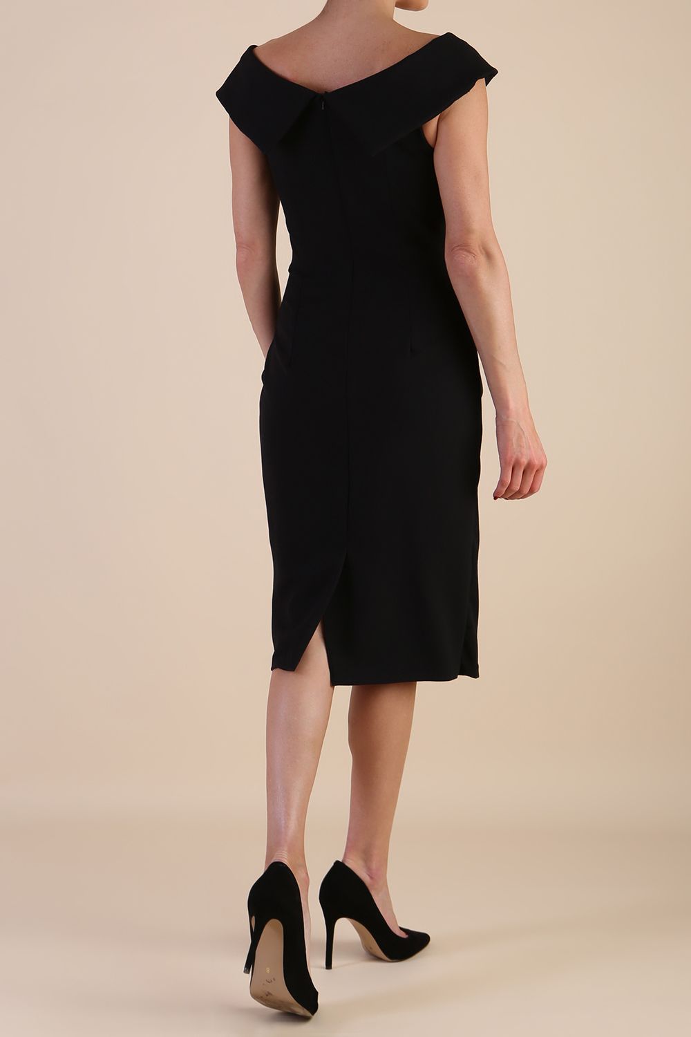 brunette model wearing diva catwalk evening pencil skirt dress sleeveless with lowered neckline and pleating on side in black colour front