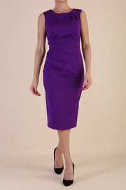  model wearing diva catwalk primula pencil skirt dress in pink with pleating on one side and sleeveless design in colour Passion Purple