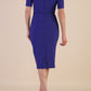 model is wearing Diva Catwalk Lydia Short Sleeve Pencil Dress with pleating across the tummy and split neckline in Deep Orient Blue