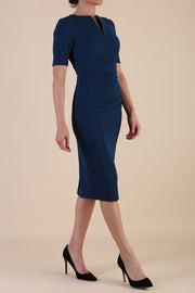 model is wearing Diva Catwalk Lydia Short Sleeve Pencil Dress with pleating across the tummy and split neckline in Autumn Teal