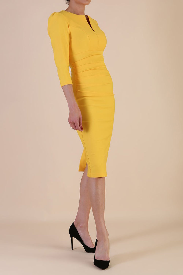 model is wearing diva catwalk seed fitzrovia sleeved pencil dress in daffodil yellow front
