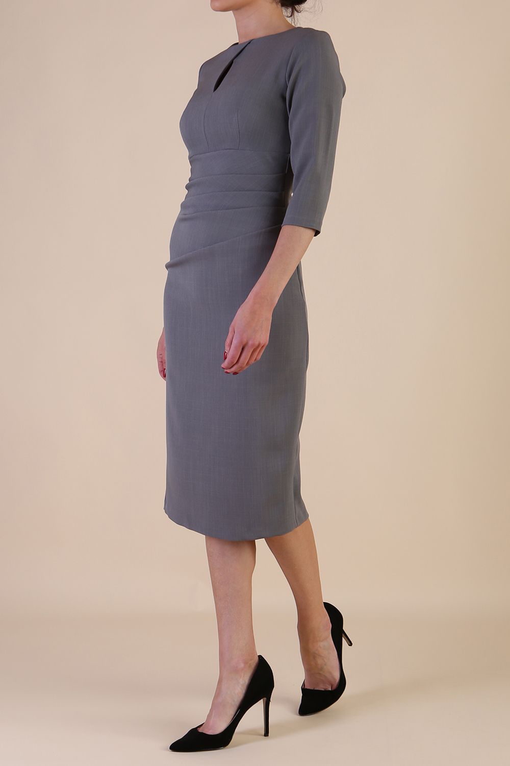 model is wearing the Diva Catwalk Ubrique pencil dress with Long sleeves and keyhole detail in Castlerock Grey fabric colour