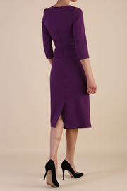 model is wearing the Diva Catwalk Ubrique pencil dress with Long sleeves and keyhole detail in Imperial Purple fabric colour