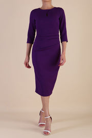 model is wearing the Diva Catwalk Ubrique pencil dress with Long sleeves and keyhole detail in Deep Purple fabric colour