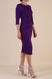 model is wearing the Diva Catwalk Ubrique pencil dress with Long sleeves and keyhole detail in Deep Purple fabric colour