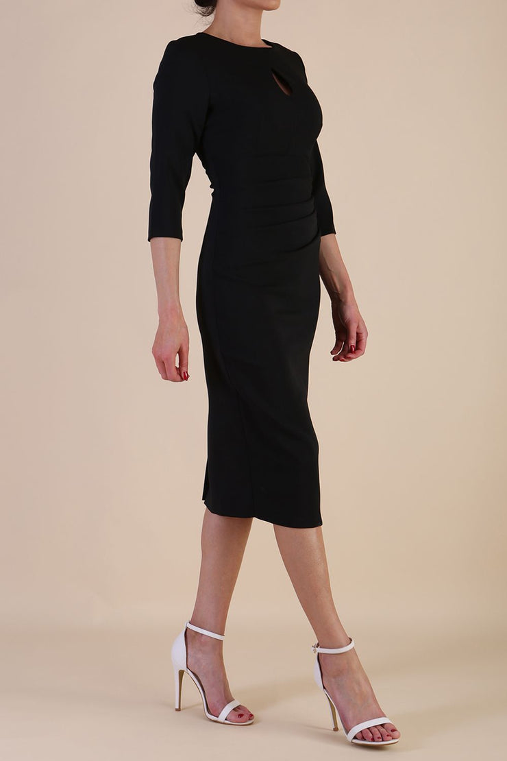 model is wearing the Diva Catwalk Ubrique pencil dress with Long sleeves and keyhole detail in Black fabric colour
