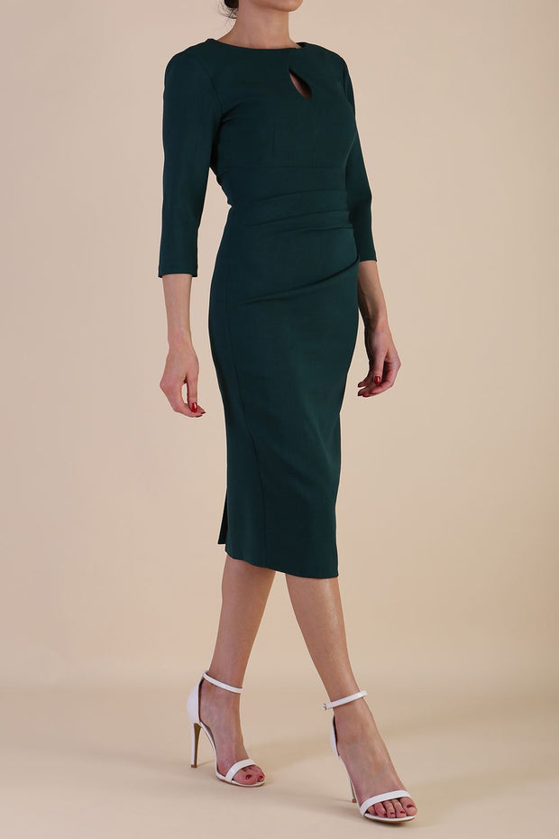 model is wearing the Diva Catwalk Ubrique pencil dress with Long sleeves and keyhole detail in Forest Green fabric colour