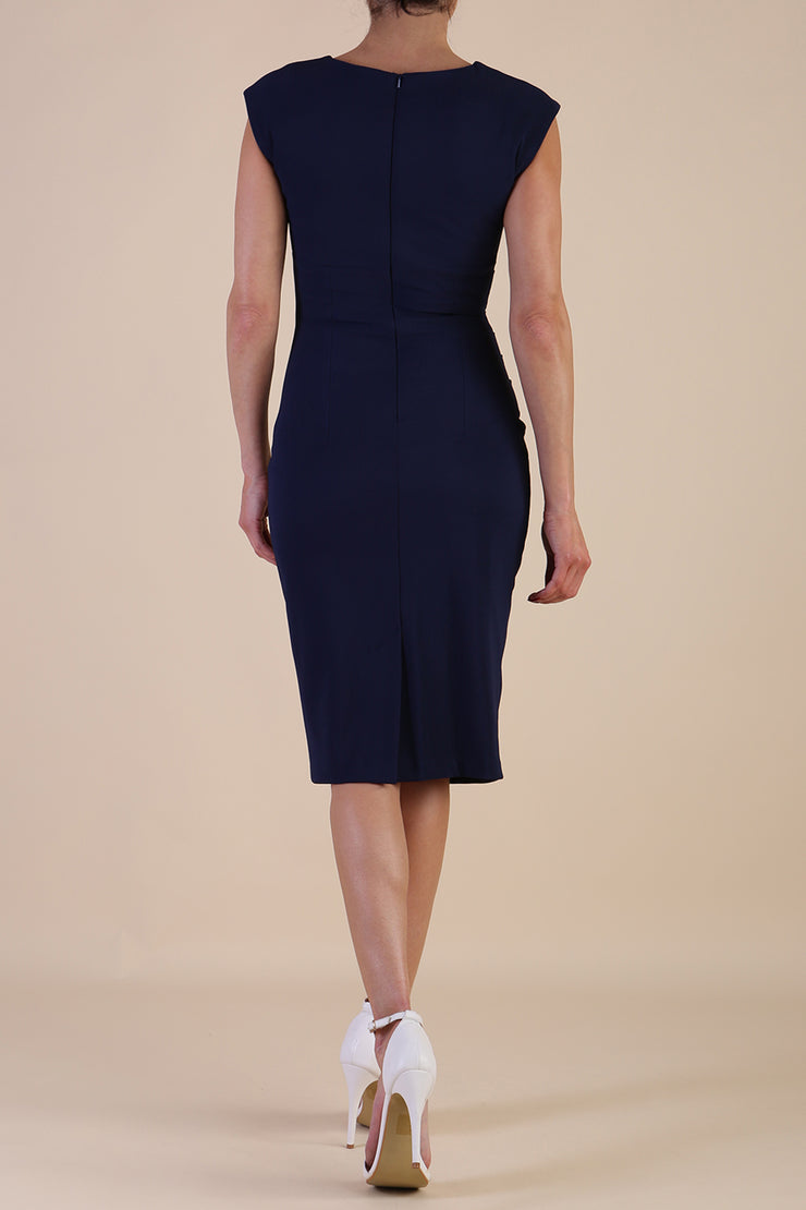 brunette model wearing diva catwalk lydia sleeveless pencil flattering fitted plain dress with split neckline and pleating across the body navy blue front