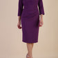 model is wearing diva catwalk miracle pencil dress with keyhole detail on a side of the front panel and gathering detail on a side or bodice panel with sleeves in Imperial Purple colour front