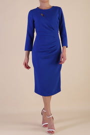 model is wearing diva catwalk miracle pencil dress with keyhole detail on a side of the front panel and gathering detail on a side or bodice panel with sleeves in cobalt blue colour front