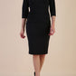 Model wearing the Diva Daphne ¾ Sleeved dress with pleat detail across the hips and ¾ sleeve length in black front