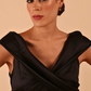 model is wearing diva catwalk casa blanca satin black pencil dress off shoulder design close up
