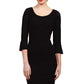 Model wearing the Diva Beatrice lace dress with round neck and pleated cuff in black lace front image