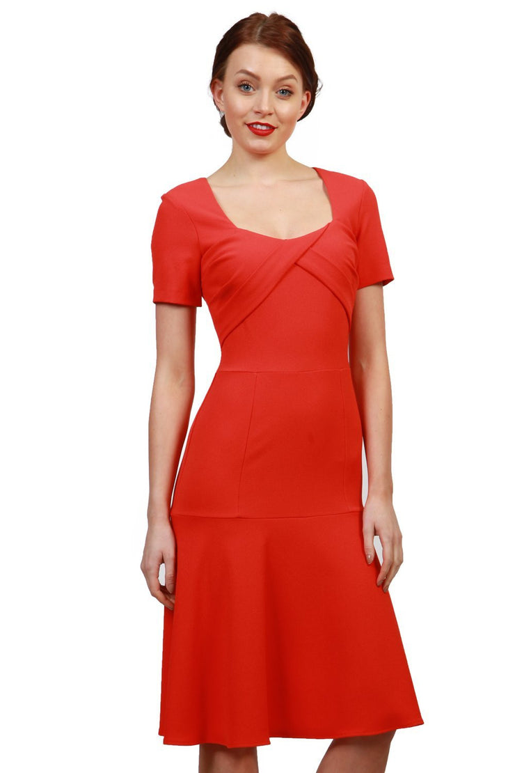 model is wearing diva catwalk madison a-line dress with square neckline and short sleeve in fiesta orange front