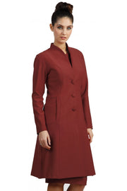 brunette model wearing diva catwalk couture fine raquella coat with buttons across the front and long sleeves with high neck and pockets in garnet red colour front