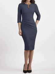 brunette model wearing seed diva catwalk milton sleeved pencil dress with a rounded neckline with a split in the middle in slate grey front