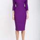 model is wearing diva catwalk kelso sleeved pencil dress with shoulder cut out and rounded high neck in purple front