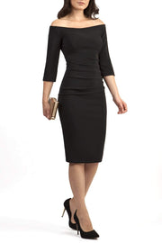 Model wearing the Diva Astra pencil dress with off shoulder design in black front image 