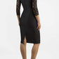 Brunetter Model is wearing seed couture lace pencil dress by diva catwalk in black back