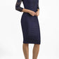 Brunetter Model is wearing seed couture lace pencil dress by diva catwalk in navy front