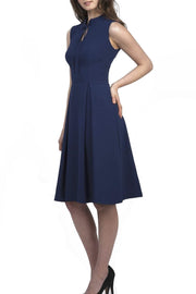 brunette model wearing diva catwalk oceana a-line swing skirt sleeveless dress with funnel neckline and tie detail in navy blue front