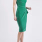 brunette model is wearing diva catwalk velvet pencil dress with V-neck and wrap skirt in golf green front