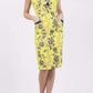 Model wearing the Diva Adeline Shift dress with V-neckline with a trim in Citronelle Green front image 