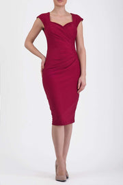 blonde model is wearing diva catwalk vivian sleeveless pencil skirt dress with overlapped bust area and lowered neckline in beet red colour front