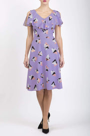 model is wearing diva catwalk layla a-line swing printed dress without sleeves in purple triangles print front
