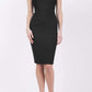 blonde model is wearing diva catwalk vivian sleeveless pencil skirt dress with overlapped bust area and lowered neckline in black colour front