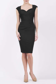 blonde model is wearing diva catwalk vivian sleeveless pencil skirt dress with overlapped bust area and lowered neckline in black colour front