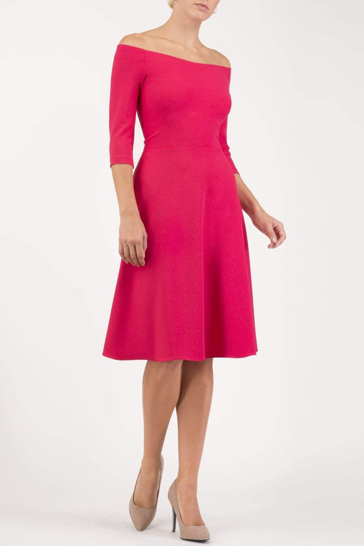 brunette model is wearing diva catwalk off shulder swing a-line islay dress with sleeves in honeysuckle pink front