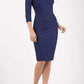 model wearing diva catwalk york pencil-skirt dress with sleeves and rounded folded collar and plearing across the tummy area in navy blue colour front