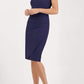 brunette model wearing diva catwalk evening pencil skirt dress sleeveless with lowered neckline and pleating on side in navy blue  colour front