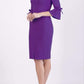 blonde model wearing diva catwalk zoe 3 4 sleeve formal dress with a split rounded neckline and split on skirt in passion purple colour front