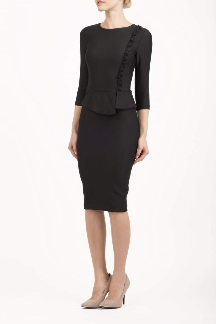 Brunette Model is wearing a three quarter sleeve couture seed pencil dress frill side detail by Diva Catwalk in black front