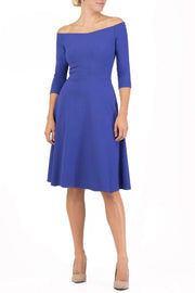 brunette model is wearing diva catwalk off shulder swing a-line islay dress with sleeves in riviera blue front