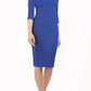 model wearing diva catwalk helston royal blue pencil dress with sleeves and cut out detail on the neckline front