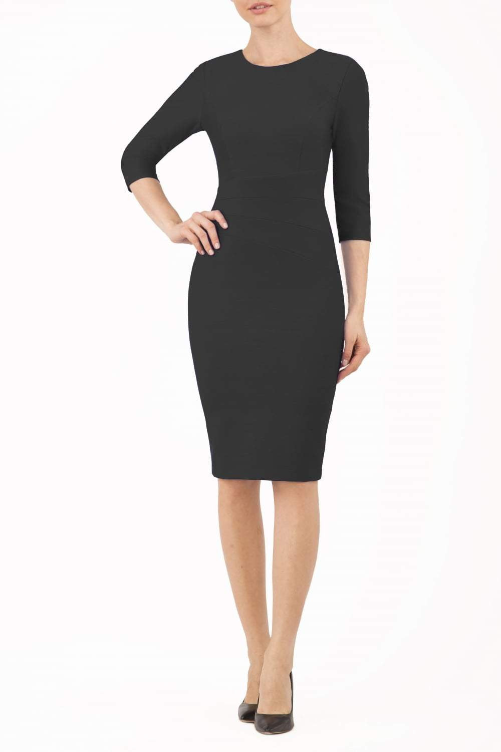 brunette model is wearing diva catwalk seed rosa plain dress with rounded neckline in navy blue front