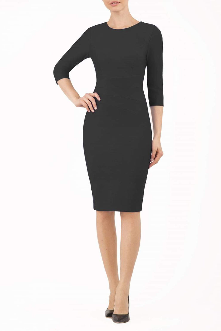 brunette model is wearing diva catwalk seed rosa plain dress with rounded neckline in black front