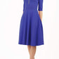 Model wearing the Diva Annette Swing Dress with V shaped neckline with zip detail in riviera blue from image