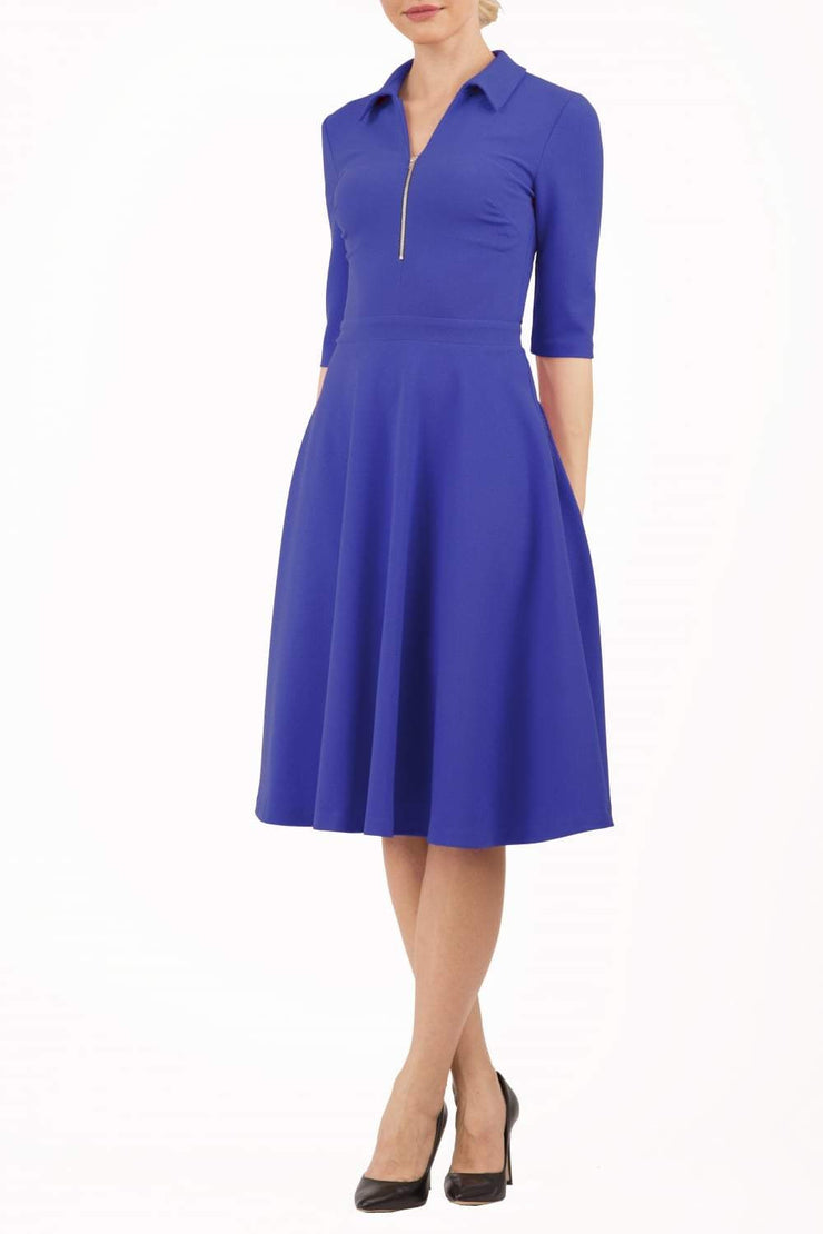 Model wearing the Diva Annette Swing Dress with V shaped neckline with zip detail in riviera blue from image