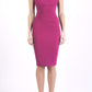 brunette model wearing diva catwalk lydia sleeveless pencil flattering fitted plain dress with split neckline and pleating across the body pink colour front