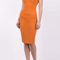 brunette model wearing diva catwalk lydia sleeveless pencil flattering fitted plain dress with split neckline and pleating across the body sun orange front