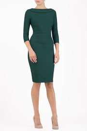 model wearing diva catwalk york pencil-skirt dress with sleeves and rounded folded collar and plearing across the tummy area in forest green colour front