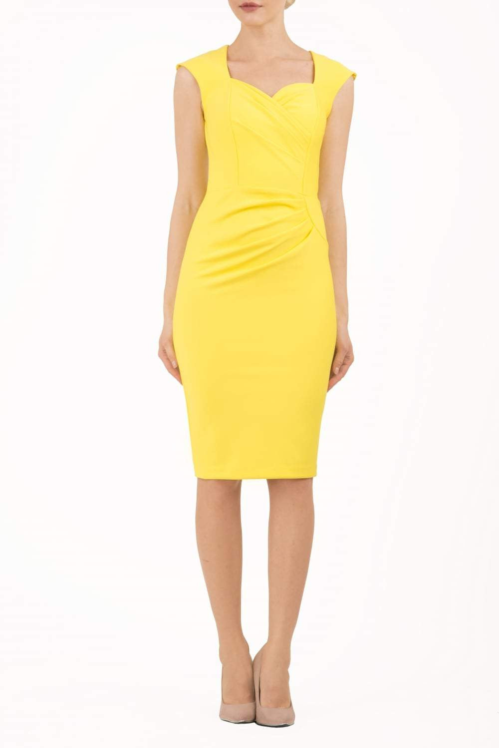 blonde model is wearing diva catwalk vivian sleeveless pencil skirt dress with overlapped bust area and lowered neckline in blazing yellow colour front